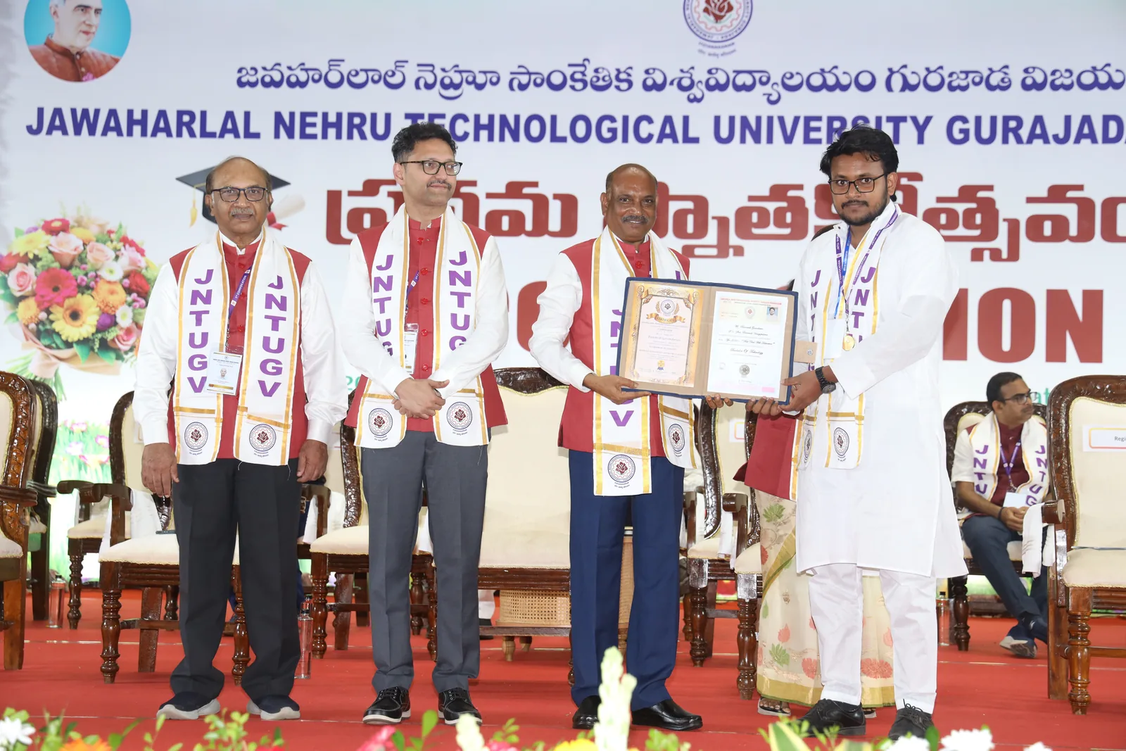Receiving the original degree certificate on the JNTUGV convocation stage, the medal already around my neck, Prof. V. V. Subba Rao holding the certificate folder open with me